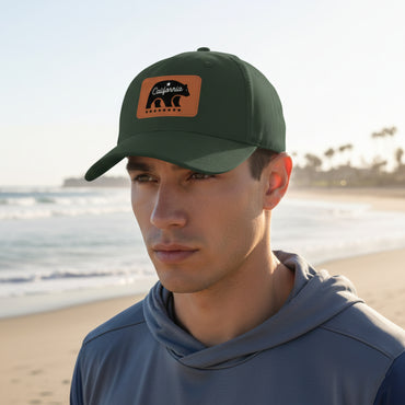 Man wearing a green cap with a patch on a beach