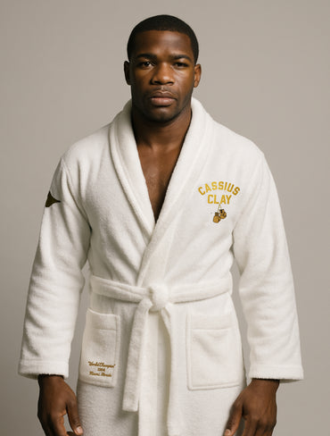 Man wearing a white robe with 'Cassius Clay' branding on a neutral background