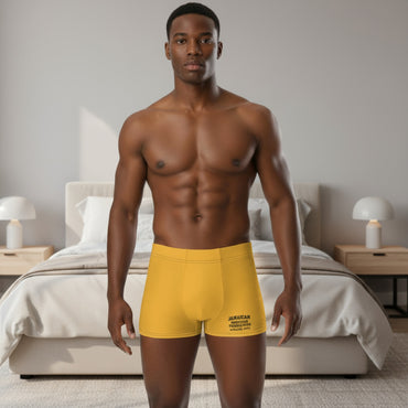 Man wearing yellow boxer briefs on a white background