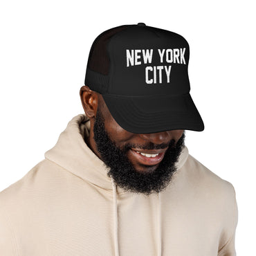 Man wearing a black cap with 'New York City' text on a white background