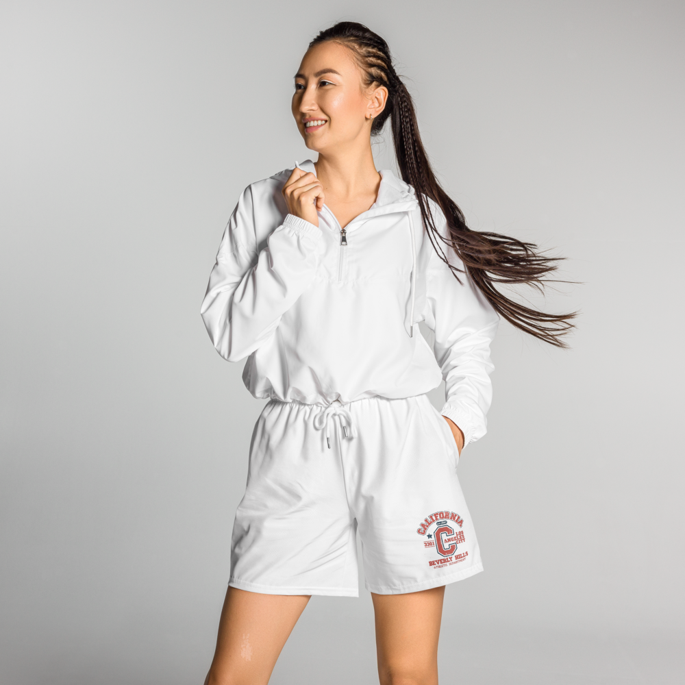 Woman wearing a white tracksuit with a logo on a gray background