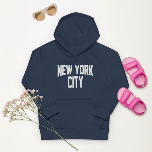 Navy hoodie with 'New York City' text, pink sandals, sunglasses, and flowers on a white background
