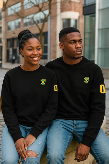 Two people wearing black sweatshirts with yellow logos sitting outdoors.