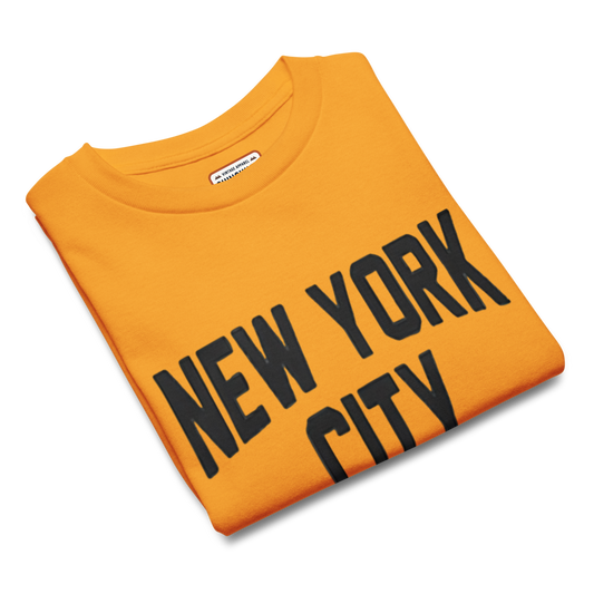 Folded orange sweatshirt with 'New York City' text on a white background