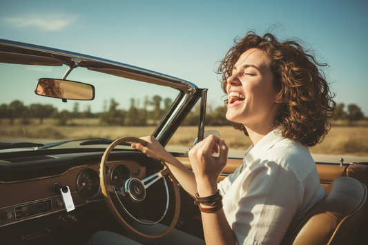 Person singing along to music while driving with a USB drive plugged into the car dashboard