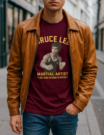 Person wearing a maroon t-shirt with Bruce Lee graphic and text, standing on a street.
