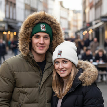 Two people wearing matching winter hats with a logo on a city street.
