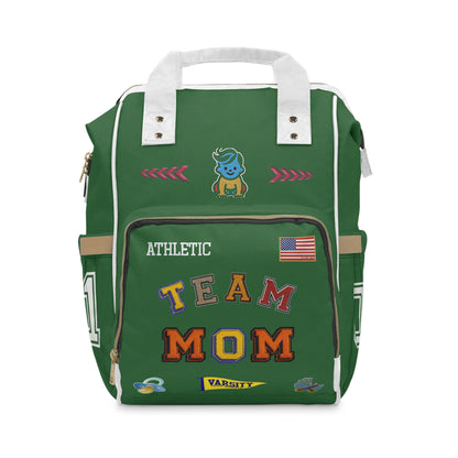 Green backpack with 'Team Mom' text and various patches on a white background