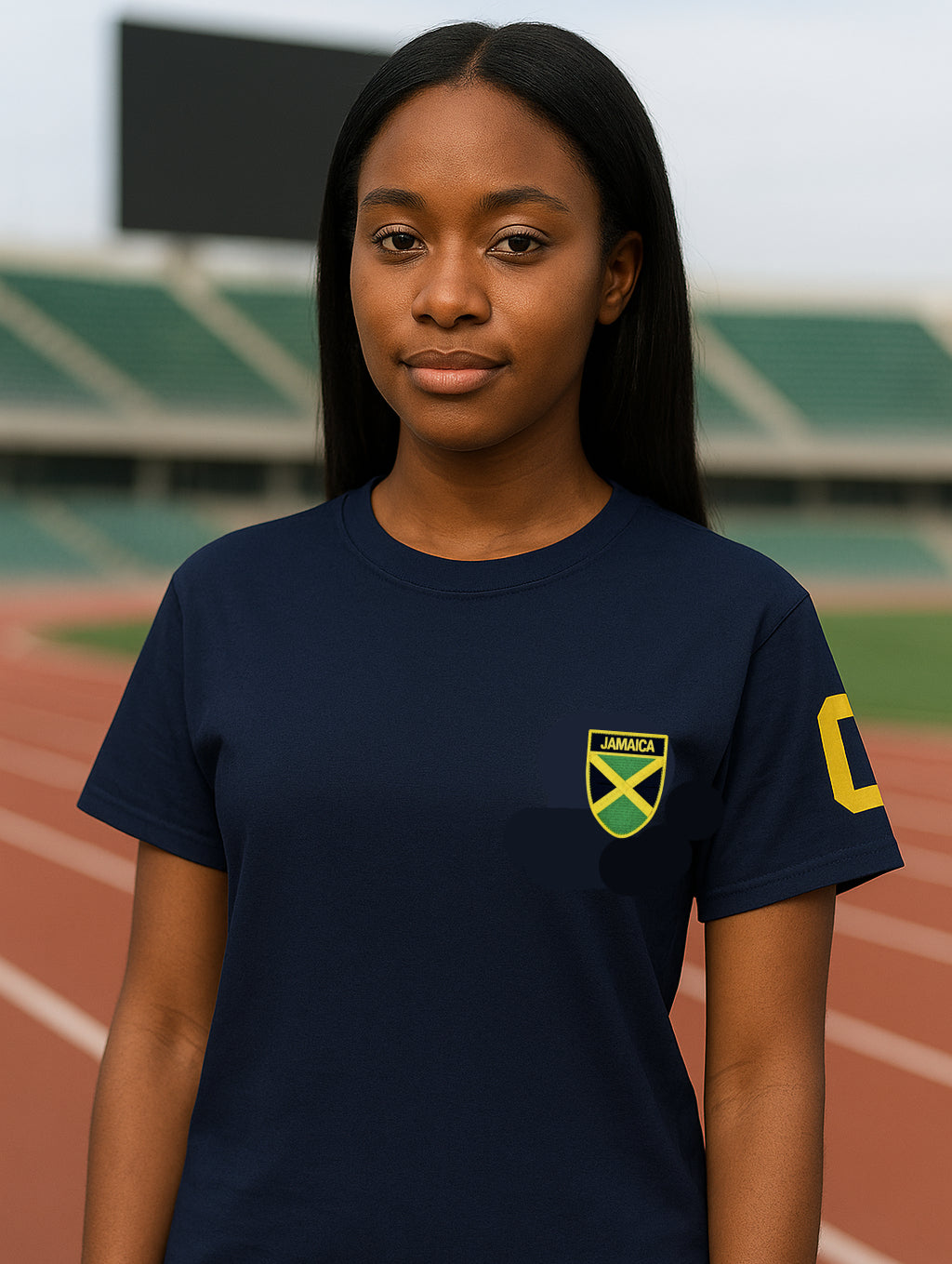 Person wearing a navy blue t-shirt with a Jamaica emblem on a track background
