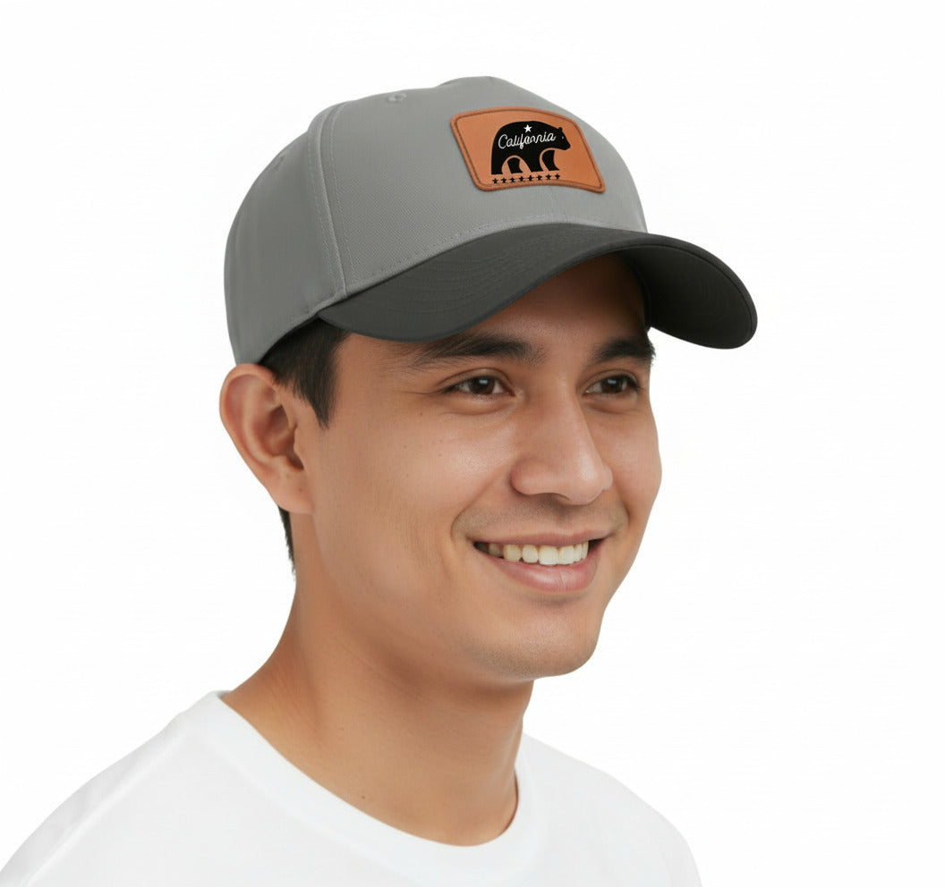 Man wearing a gray cap with a leather patch on a beige background