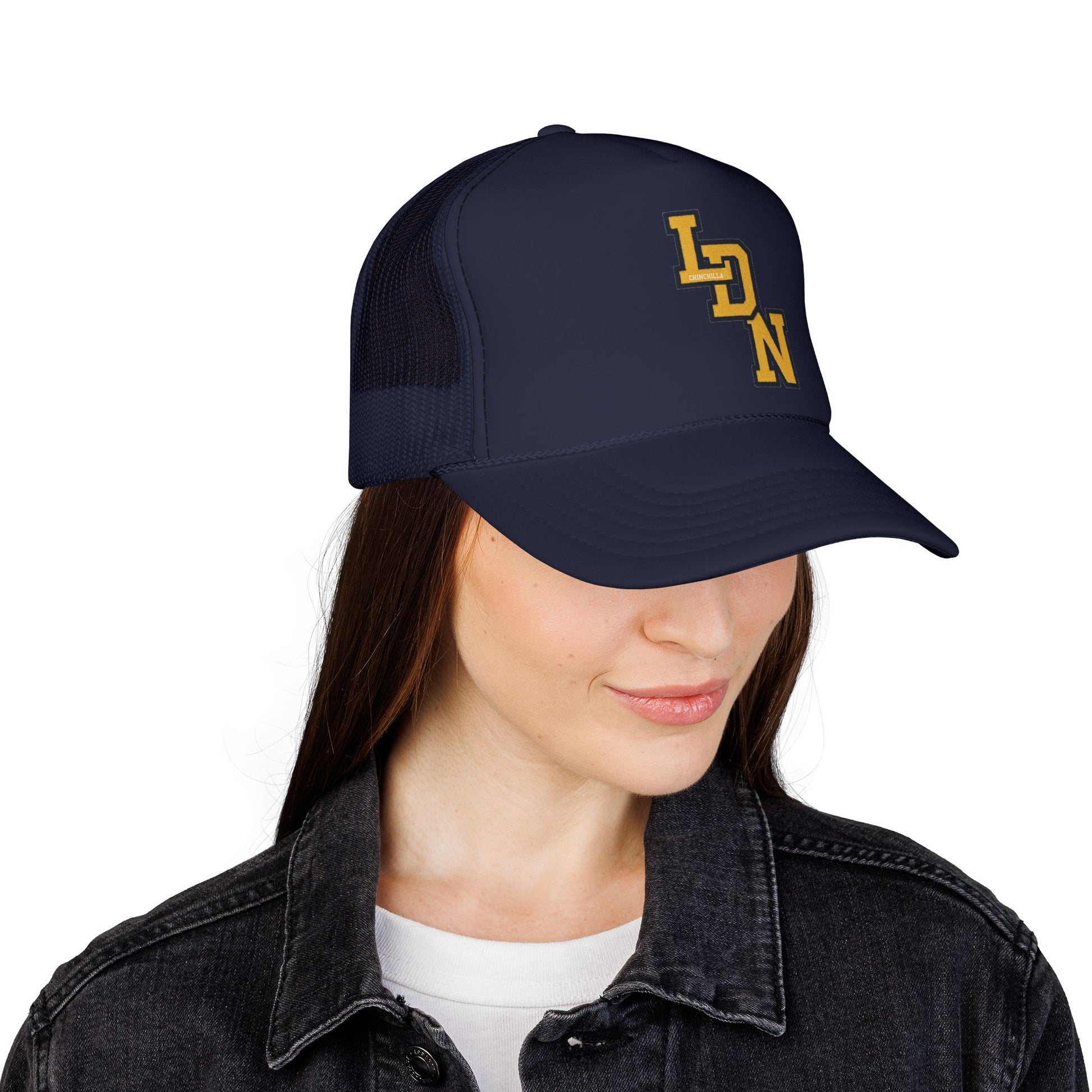 Person wearing a navy blue cap with 'LDN' logo on a white background