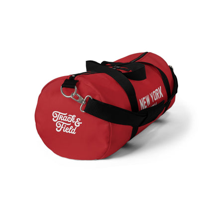Red duffel bag with 'Track & Field New York' text on a white background