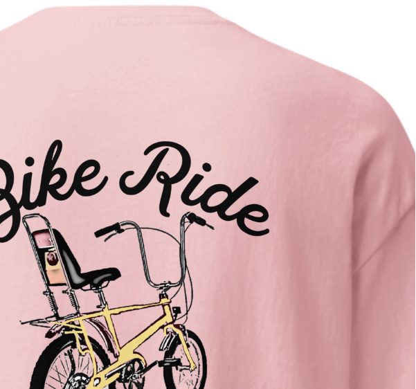 Pink shirt with a bicycle graphic and 'Bike Ride' text on a white background