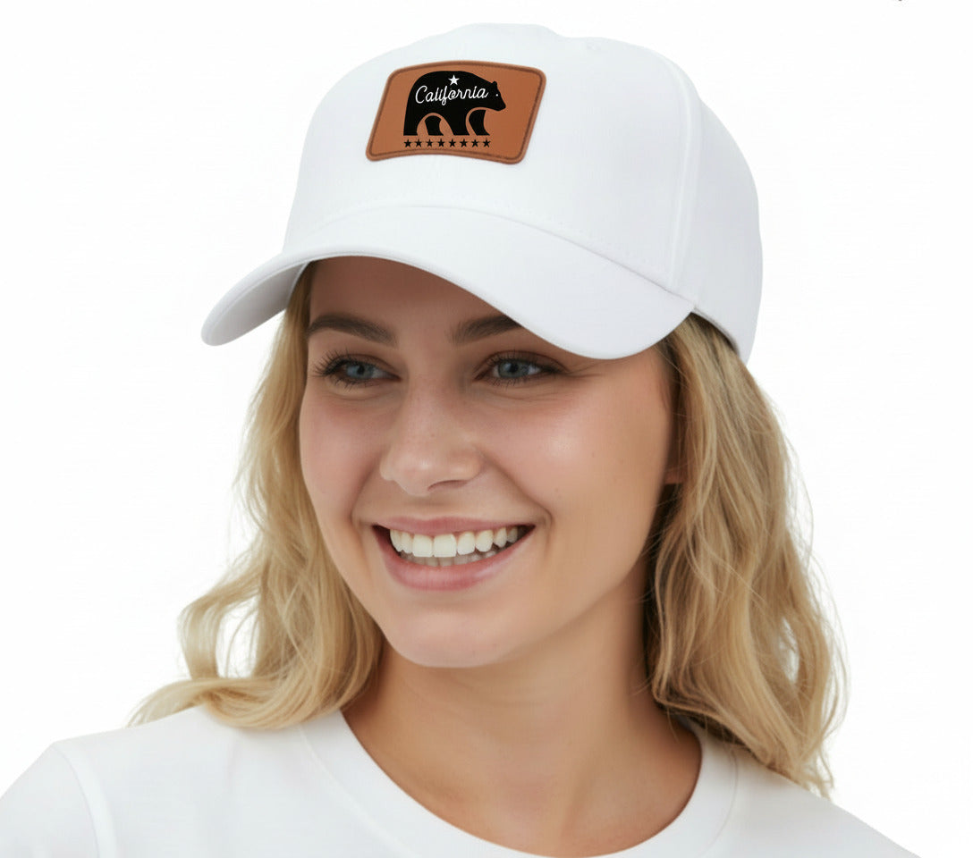 Woman wearing a white cap with a leather patch on a beige background