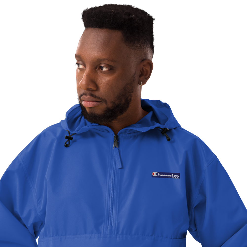 Man wearing a blue Champion jacket on a white background
