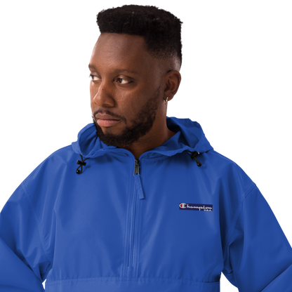 Man wearing a blue Champion jacket on a white background
