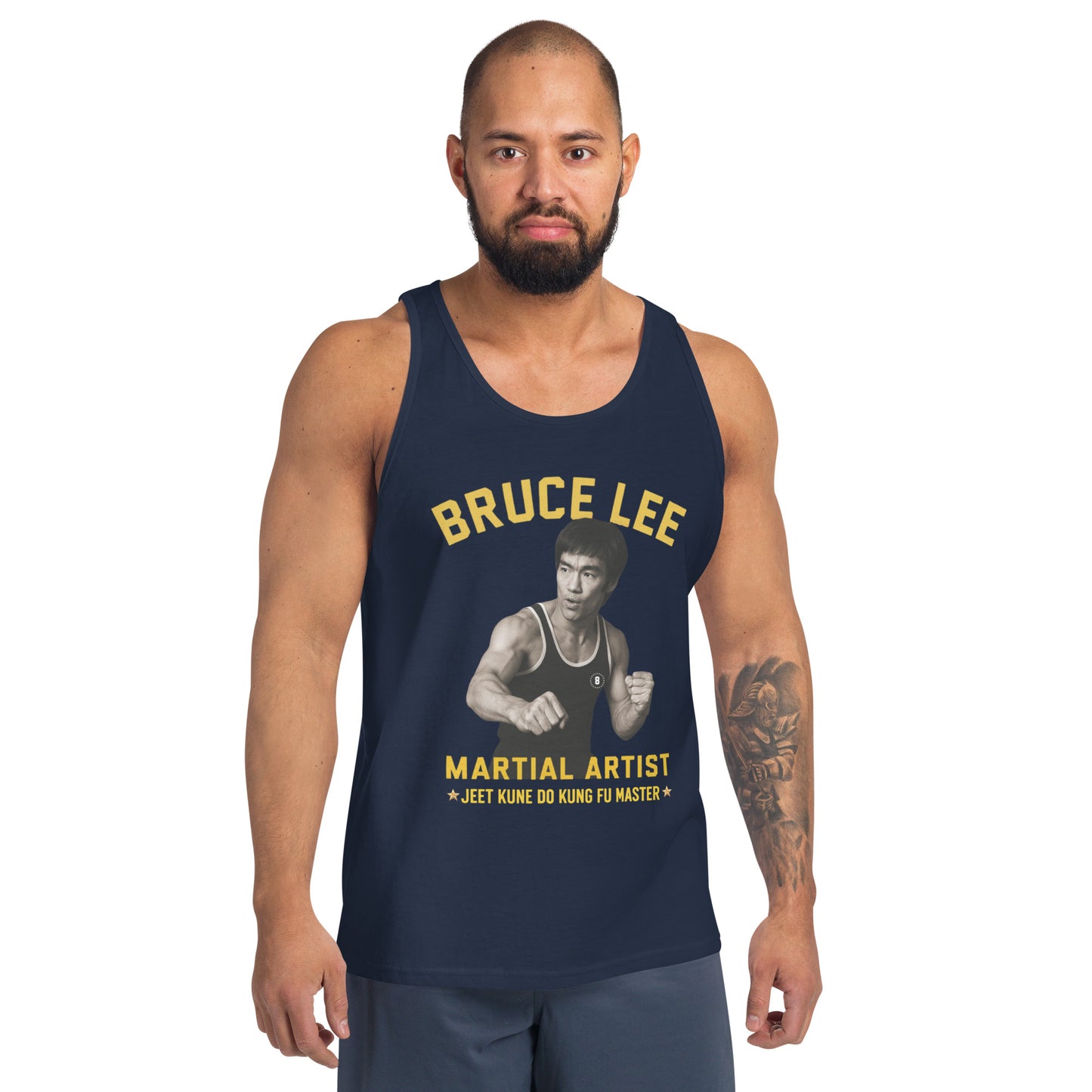 Man wearing a navy tank top with Bruce Lee graphic and text on a white background