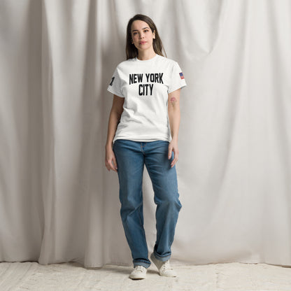 Person wearing a white 'New York City' t-shirt and blue jeans against a plain background