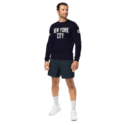 Man wearing a black 'New York City' sweatshirt and dark shorts on a white background