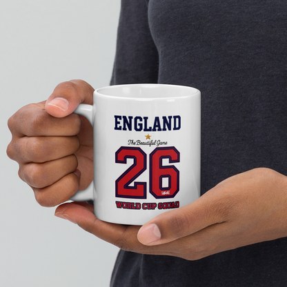 Person holding a white mug with 'England' and number '26' printed on it.